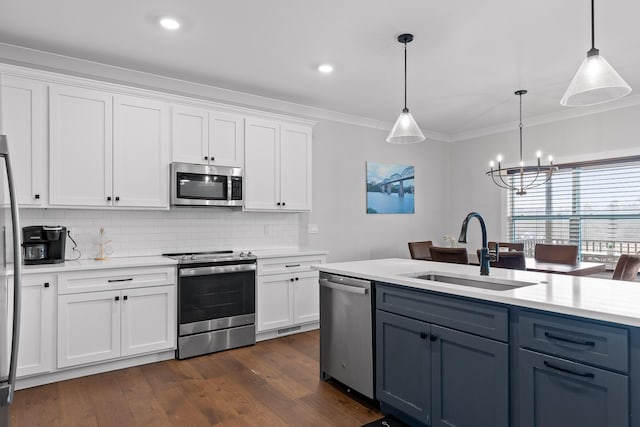 kitchen with white cabinetry, sink, decorative light fixtures, and stainless steel appliances