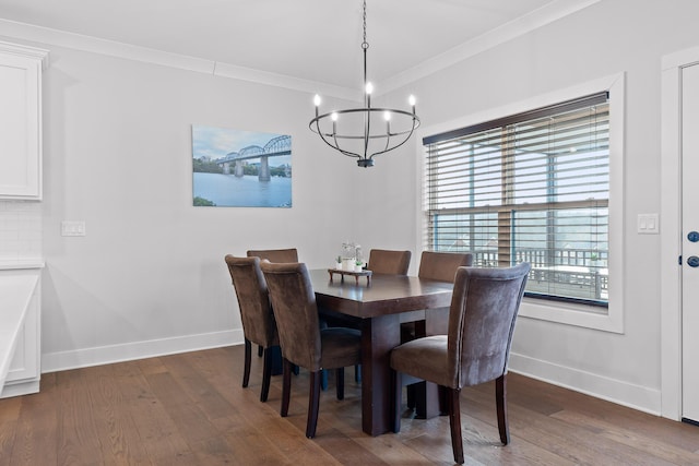 dining room featuring ornamental molding, dark hardwood / wood-style floors, and a chandelier