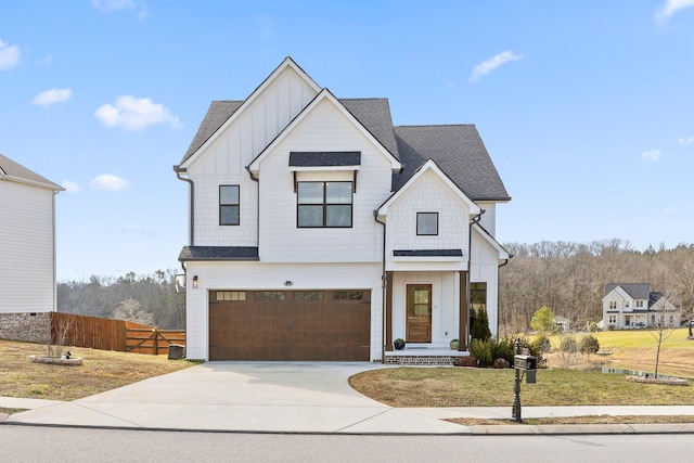 modern inspired farmhouse featuring a garage and a front yard