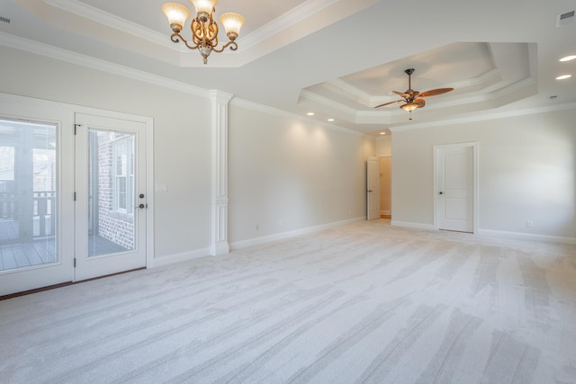 carpeted spare room with a raised ceiling, crown molding, and ceiling fan with notable chandelier