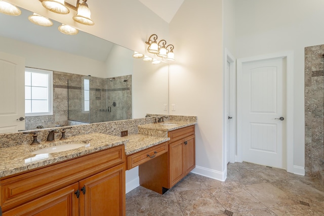 bathroom with vaulted ceiling, vanity, and a shower with door