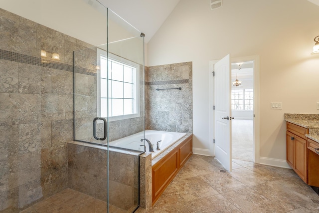 bathroom with vaulted ceiling, shower with separate bathtub, and vanity