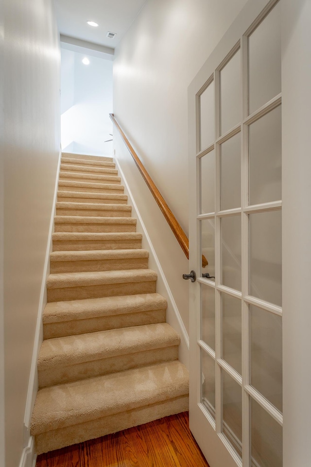 stairs with hardwood / wood-style floors