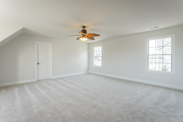 additional living space featuring ceiling fan and light colored carpet