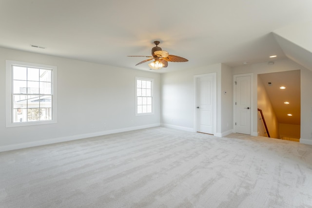 unfurnished room with light colored carpet and ceiling fan