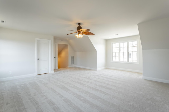 bonus room with lofted ceiling, light colored carpet, and ceiling fan