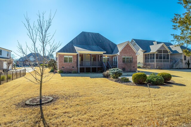 view of front of home with a porch and a front lawn