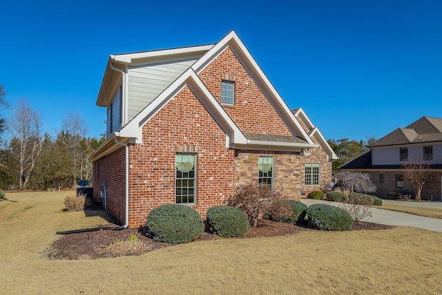 view of side of home with a lawn