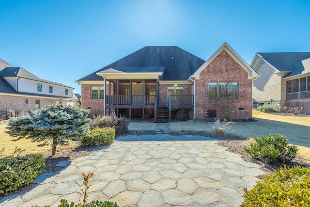 view of front of property featuring a sunroom and a patio