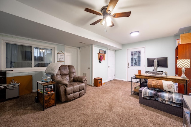 carpeted living room with ceiling fan