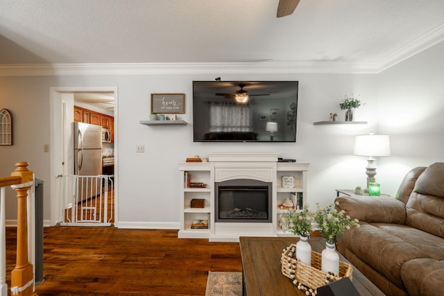 living room featuring ceiling fan, dark wood-type flooring, crown molding, and a textured ceiling