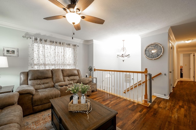 living room with a textured ceiling, dark wood-type flooring, and ornamental molding