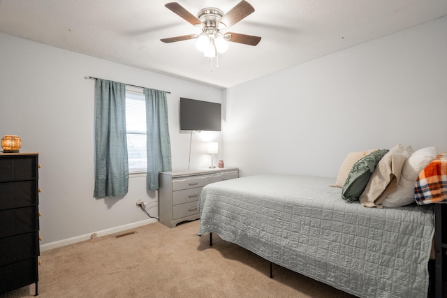 bedroom with light carpet and ceiling fan