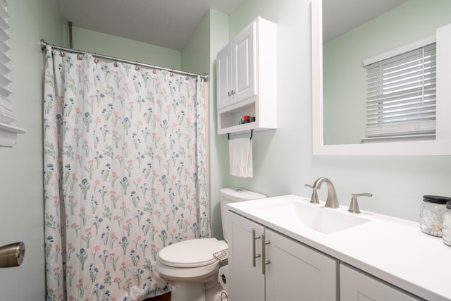 bathroom featuring vanity, a shower with curtain, and toilet