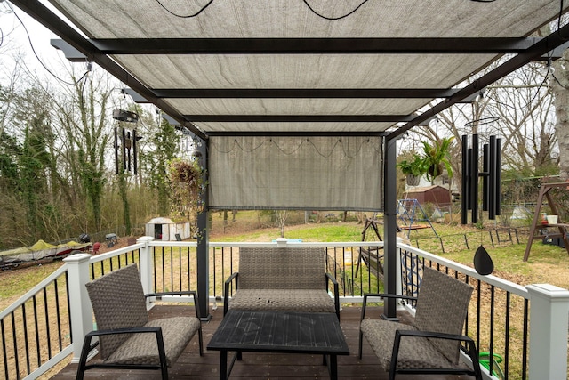 deck with a shed, a playground, a pergola, and a lawn