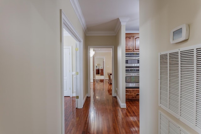 corridor with dark hardwood / wood-style flooring and crown molding