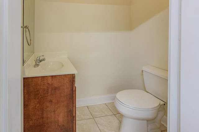 bathroom with tile patterned flooring, vanity, and toilet