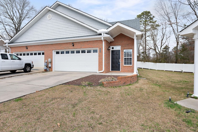 view of front of house with a garage and a front lawn