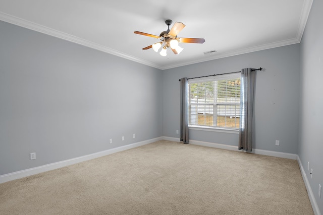 spare room featuring crown molding, ceiling fan, and light carpet