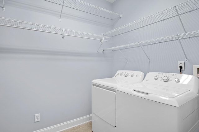 clothes washing area featuring independent washer and dryer