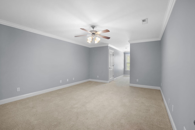 empty room with crown molding, light colored carpet, and ceiling fan