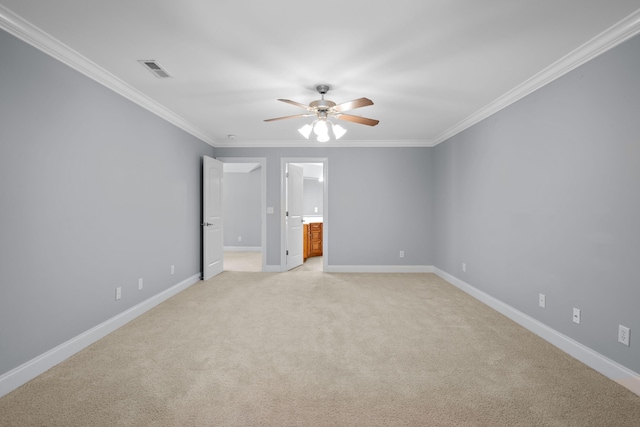 carpeted spare room featuring ceiling fan and ornamental molding