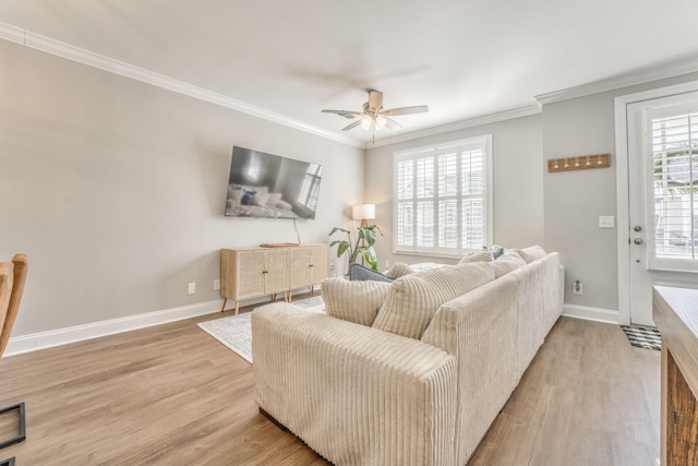 living room with hardwood / wood-style flooring, ornamental molding, and ceiling fan