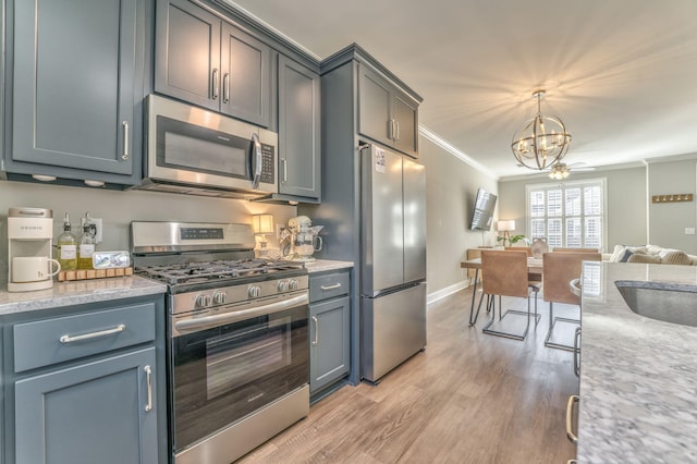 kitchen featuring appliances with stainless steel finishes, ornamental molding, decorative light fixtures, a chandelier, and light wood-type flooring