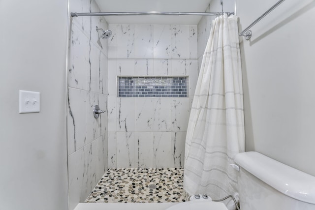 bathroom featuring toilet and a shower with curtain