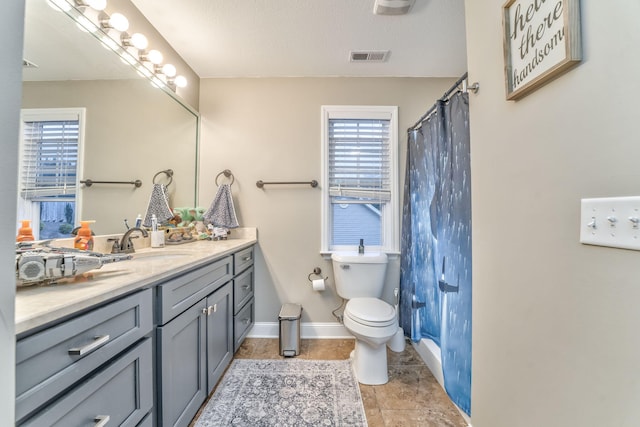 bathroom featuring vanity, toilet, and a shower with shower curtain