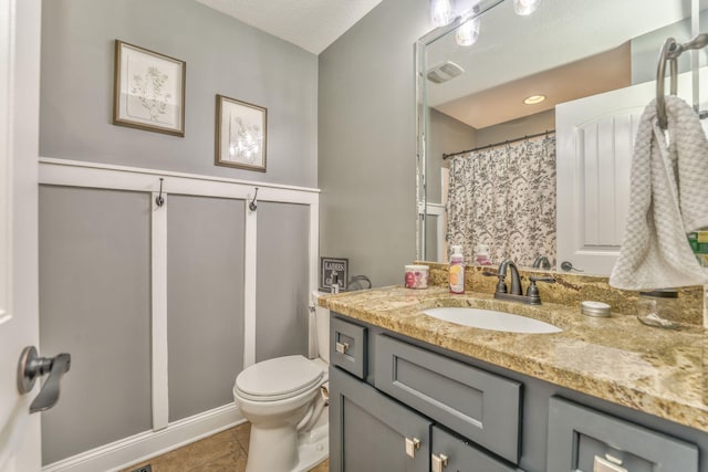 bathroom with tile patterned floors, toilet, and vanity