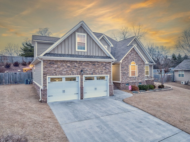 view of front of property with a garage and cooling unit