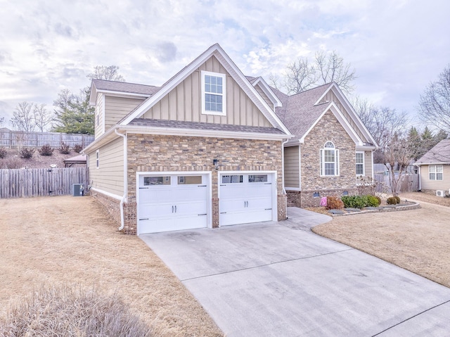 view of front of home featuring a garage and central air condition unit