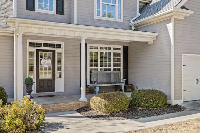 view of exterior entry featuring covered porch