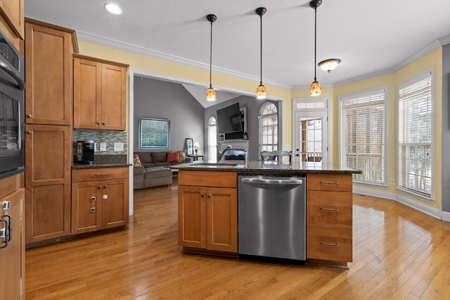 kitchen featuring crown molding, sink, decorative light fixtures, and stainless steel dishwasher