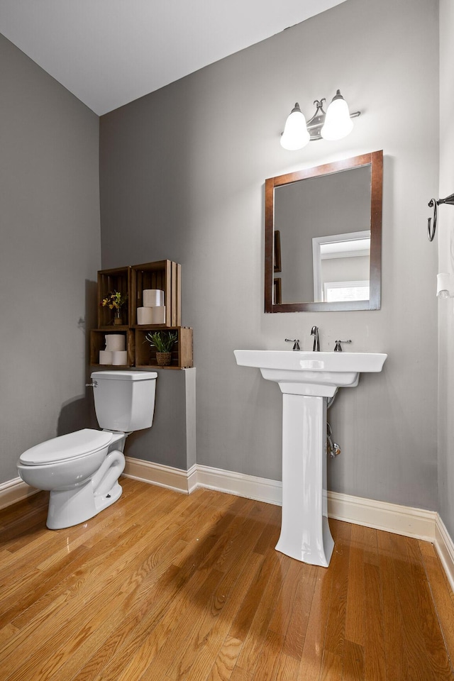 bathroom with wood-type flooring and toilet