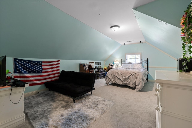 bedroom with lofted ceiling and carpet