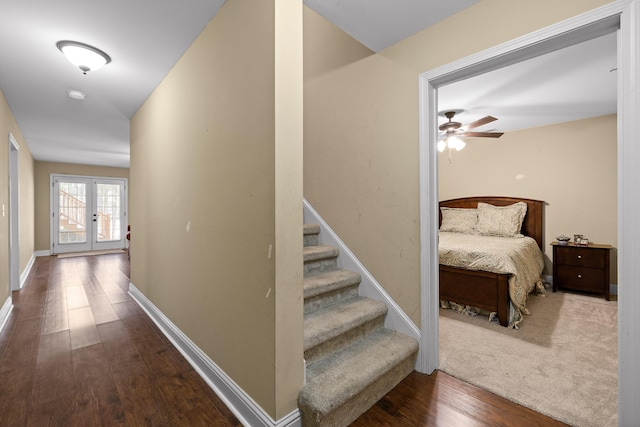 hallway with french doors and hardwood / wood-style floors