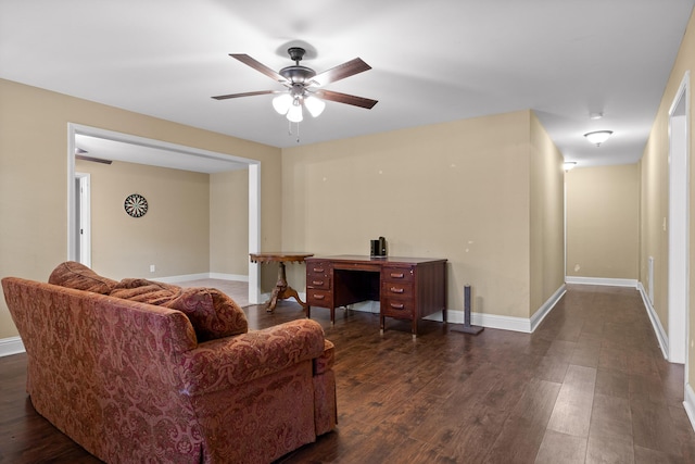 living room featuring ceiling fan and dark hardwood / wood-style floors