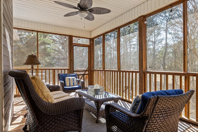 sunroom featuring ceiling fan