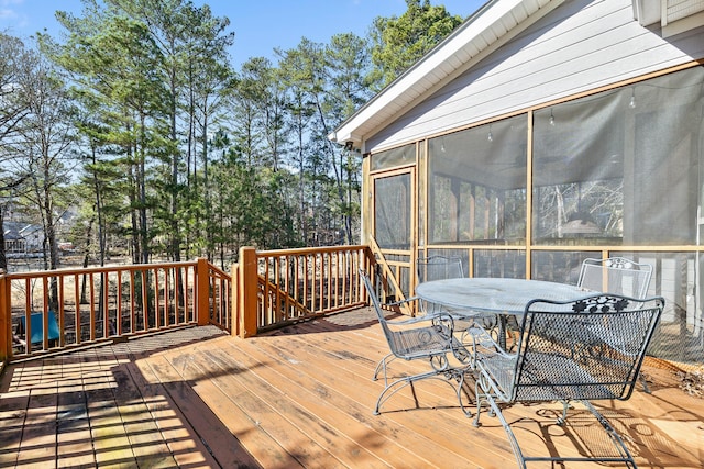 wooden terrace featuring a sunroom