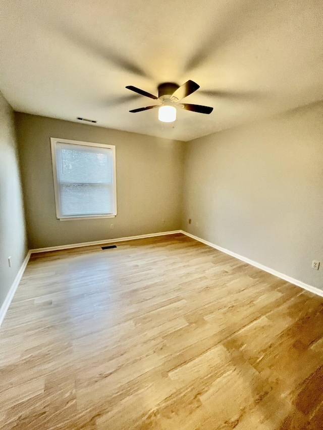 spare room featuring light hardwood / wood-style floors and ceiling fan