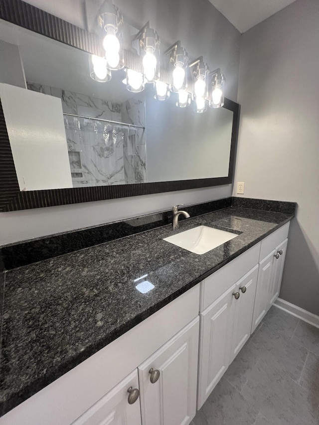 bathroom with vanity and tiled shower