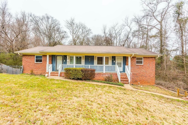 ranch-style home with a front lawn and a porch