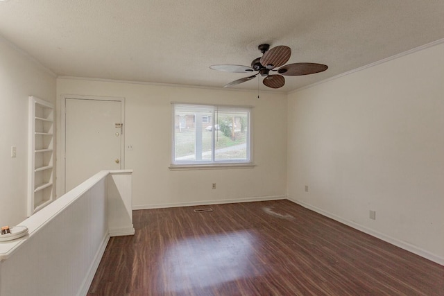 spare room featuring ceiling fan, crown molding, dark wood-type flooring, and a textured ceiling