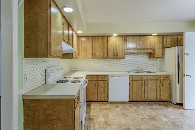 kitchen with sink, white appliances, and backsplash