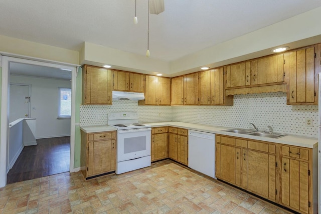 kitchen with sink, white appliances, and decorative backsplash