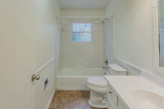 full bathroom featuring tiled shower / bath, vanity, and toilet