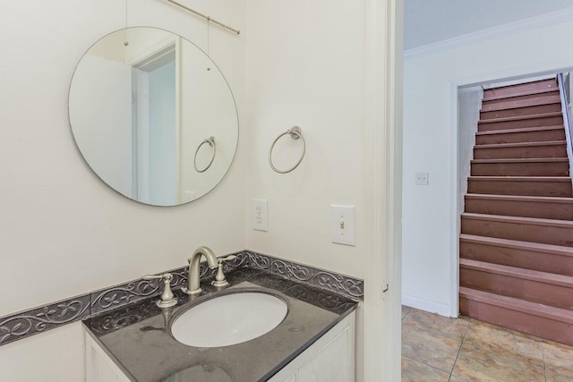 bathroom featuring ornamental molding and vanity