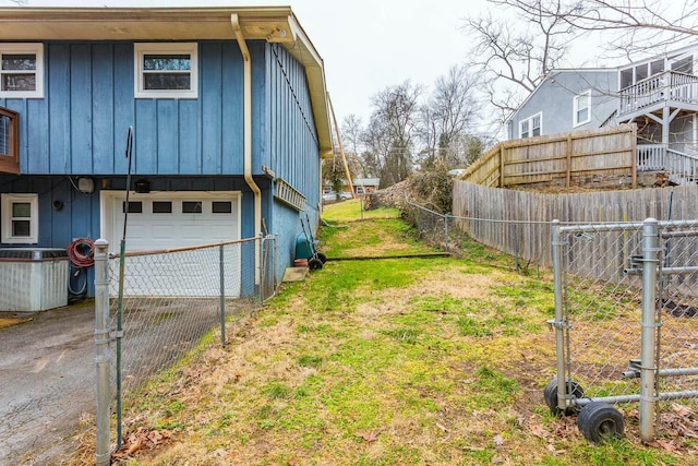 view of yard featuring a garage and central AC unit